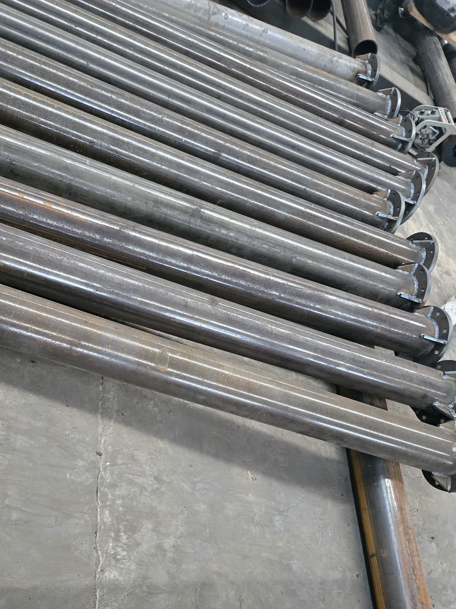 Galvanised structural tubes laid out in the workshop