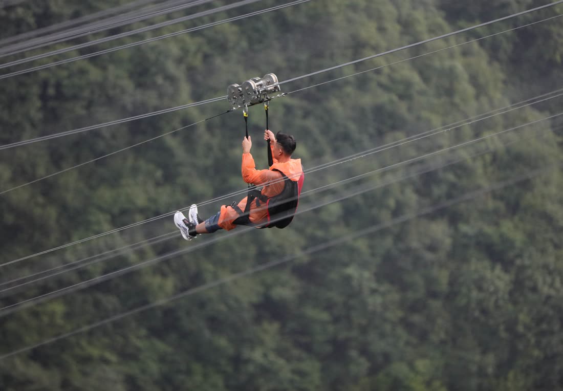 Zipline crossing a canyon with rock walls